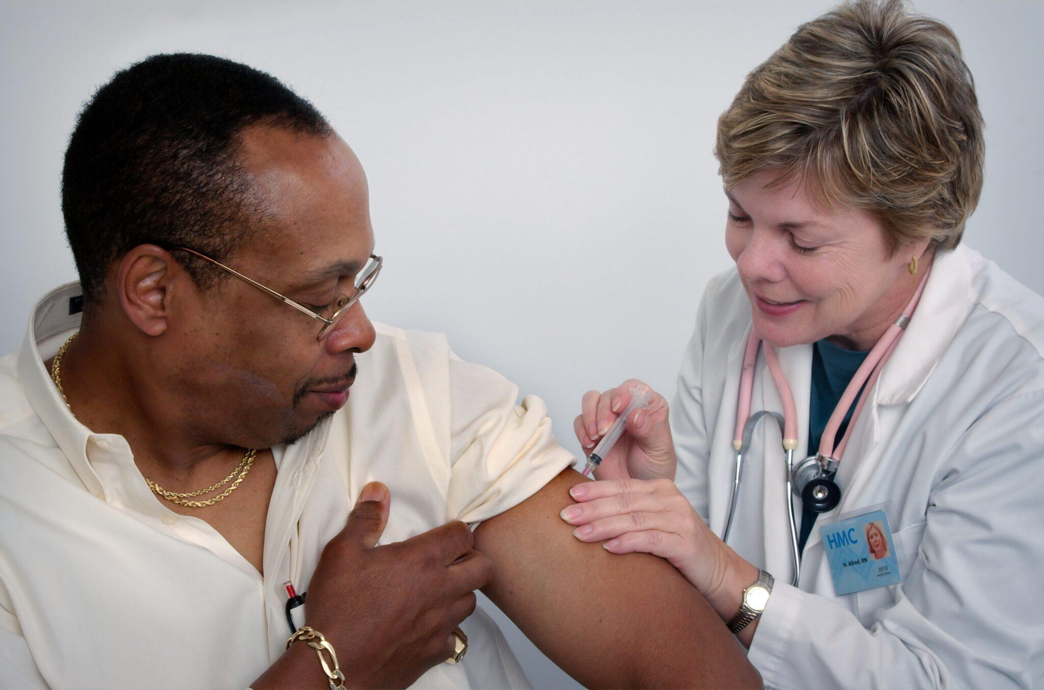 a Nurse Practitioner giving injection to a patient